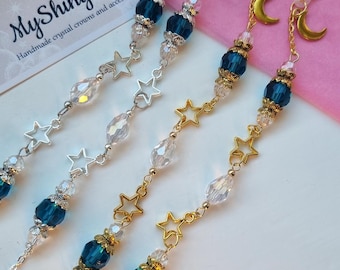 May include: Eyeglass chains with celestial themes. The chains feature blue beads, clear crystal beads, and star and moon charms. The chains are available in silver and gold tones. The logo "MyShinyBox" is visible in the background.