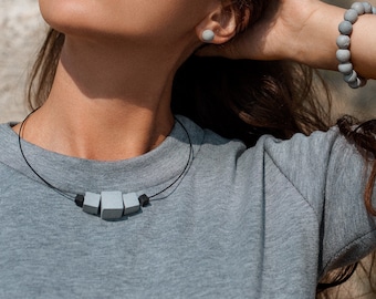 Concrete cube necklace with black Lava stone