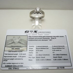 May include: A GSL Laboratories diamond ring certificate with a photo of a white gold diamond ring with round brilliant cut diamonds. The certificate states the ring is 14 karat white gold with a total diamond weight of 0.99 carats. The certificate number is GSL 578402 and the date is Jul-10-09.