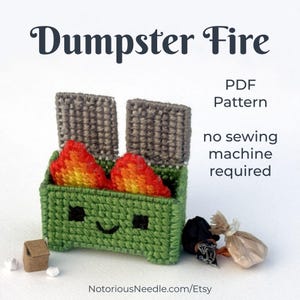 May include: A green, handmade, smiling dumpster with flames, and the text "Dumpster Fire". The PDF pattern is available with no sewing machine required. Includes small trash items. NotoriousNeedle.com/Etsy.