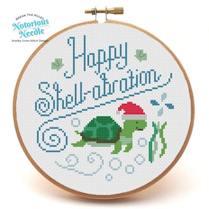 May include: Cross stitch pattern featuring a turtle wearing a Santa hat and the text "Happy Shell-ebration".