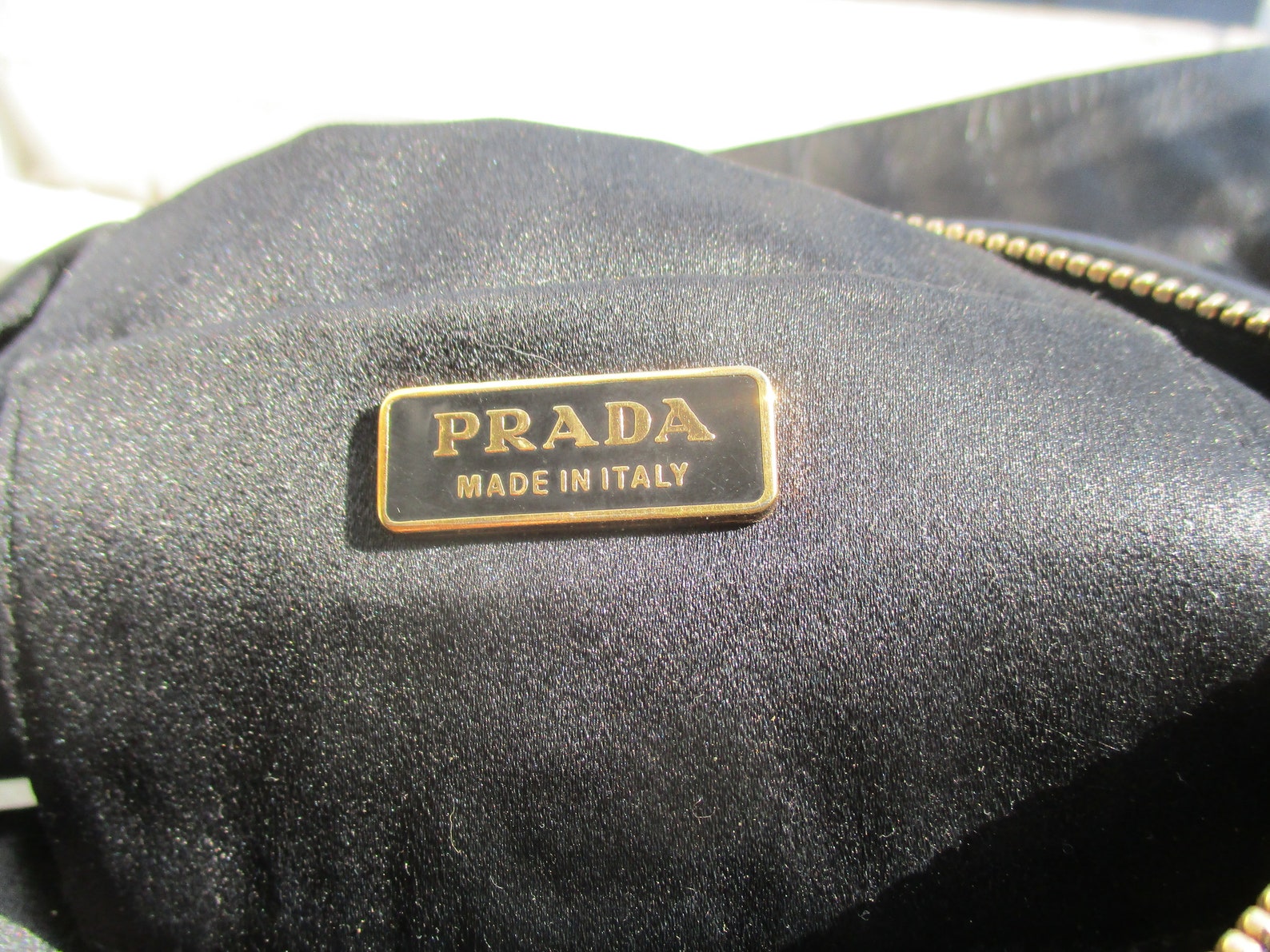 prada triangle logo clutch