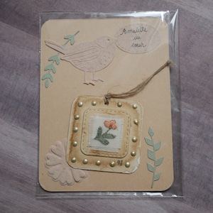 Small heart amulet, hand-embroidered lucky charm.