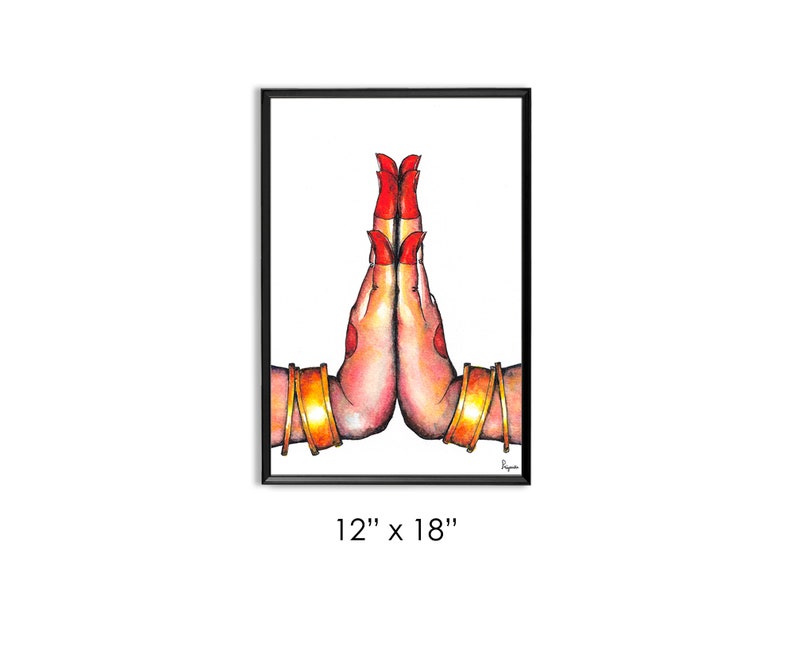 May include: A watercolor painting of two hands in a prayer position, with red nail polish and gold bangles. The hands are depicted against a white background, framed in black.