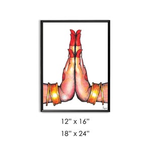 May include: A watercolor painting of two hands in a prayer position, with red nail polish and gold bangles. The hands are against a white background and framed in black.