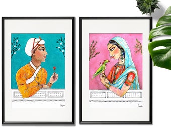 May include: Two framed watercolor paintings depicting a couple in traditional Indian clothing. The man is wearing a yellow and orange outfit with a white turban and holding a red flower. The woman is wearing a blue and orange outfit with a pink headscarf and holding a green parrot. Both paintings have a white background with black frames.