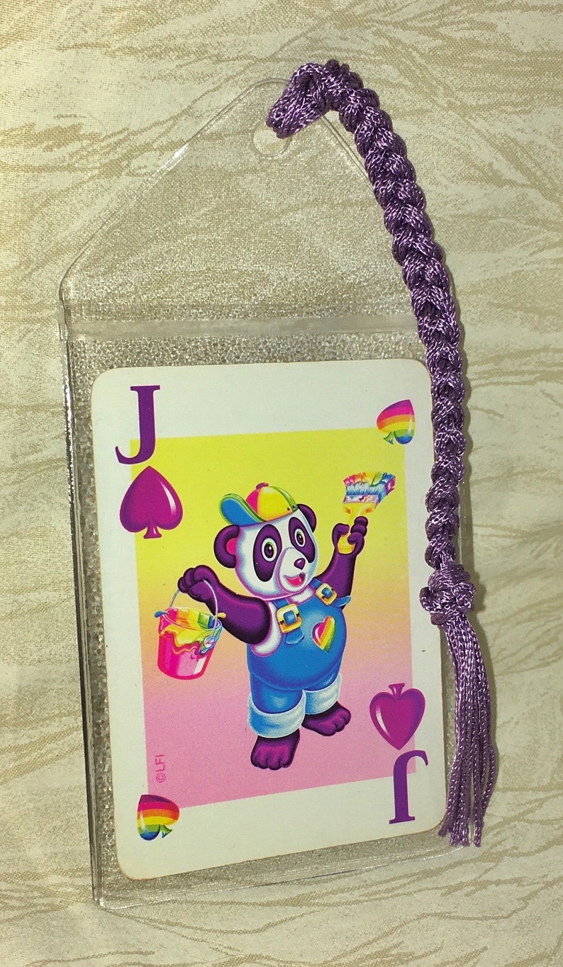 May include: A Jack of Spades playing card with a cartoon panda illustration, held in a clear plastic sleeve. The card has a purple braided bookmark attached. The panda is holding a paint bucket and brush.