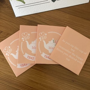 May include: Four peach-coloured cards with a white teapot design and the text "As you sip this cup of tea remember the happy times you shared with me" and "Mar 1942" on the cards.