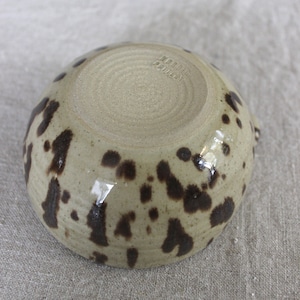 Bottom view of handmade stoneware matcha bowl, showing wheel-thrown texture and trimmed foot.