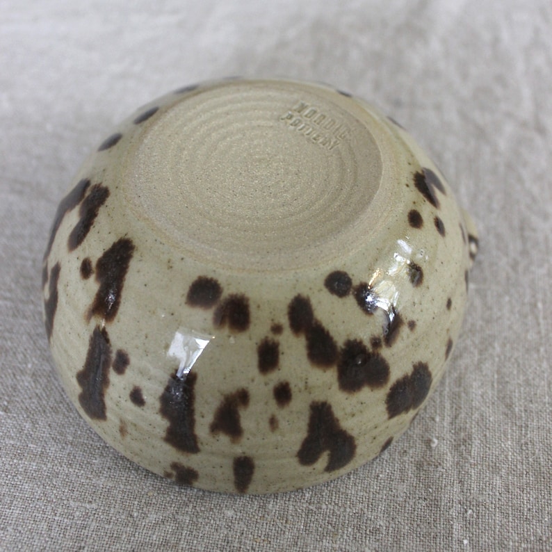 Bottom view of handmade stoneware matcha bowl, showing wheel-thrown texture and trimmed foot.