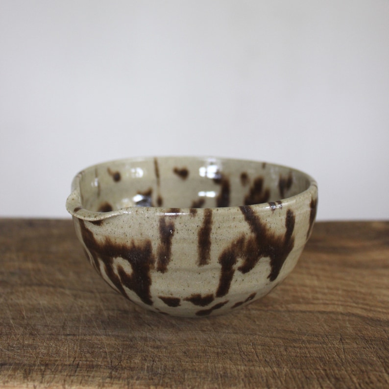 Speckled ceramic matcha bowl on wooden surface, handmade in my Nordic Pottery studio.