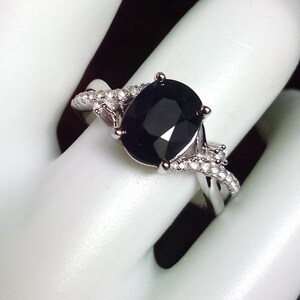 2 carat midnight blue black sapphire ring with a twisted band and white sapphire accents. Sterling silver. Size 7.