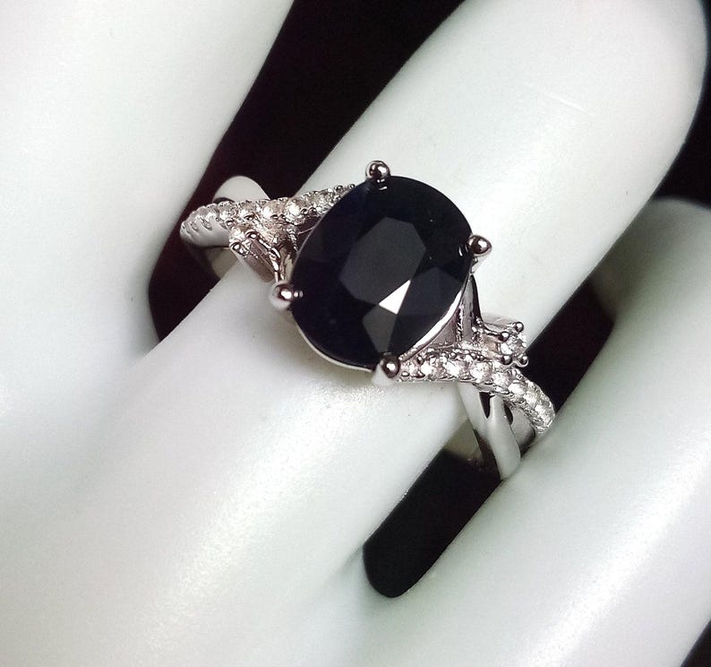 2 carat midnight blue black sapphire ring with a twisted band and white sapphire accents. Sterling silver. Size 7.