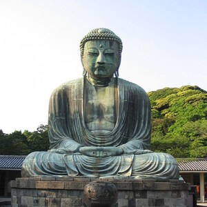 May include: A large, green bronze statue of a seated Buddha. The statue is in a meditative pose with hands resting in the lap. The Buddha is wearing a robe and has a serene expression.