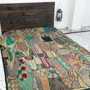 May include: A green patchwork quilt featuring a range of colourful patterns and textures. The quilt is made from various fabrics and is adorned with embroidery and sequins.