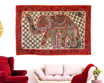 May include: A colorful patchwork elephant wall tapestry with red, green, and gold accents. The tapestry is framed with a red border and features intricate embroidery details.