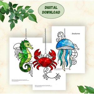 May include: Digital download of stained glass patterns featuring a seahorse, crab, and jellyfish. The seahorse is green and yellow, the crab is red, and the jellyfish is blue and teal. Each design is suspended by a chain.