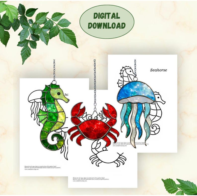 May include: Digital download of stained glass patterns featuring a seahorse, crab, and jellyfish. The seahorse is green and yellow, the crab is red, and the jellyfish is blue and teal. Each design is suspended by a chain.