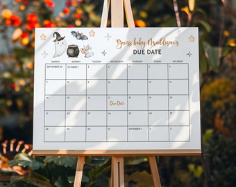 May include: A white calendar with a black and white illustration of a ghost, a cauldron, and a bat. The calendar is titled "Guess Baby Maddison's Due Date" and has dates from September to October.