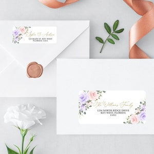 May include: Two white envelopes with floral return address labels. The top label reads "Jyle & Arlin 123 Main St, Key West Florida 100". The bottom label reads "The Willis Family 1234 North Ridge Drive Key West, Florida 11011". Both labels feature watercolor floral designs with pink and purple flowers.