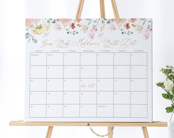 May include: A white calendar with a floral border and gold lettering. The calendar is labeled "Guess Baby Maddison's Birth Date" and shows the months of June and July. The due date is marked on July 18th.
