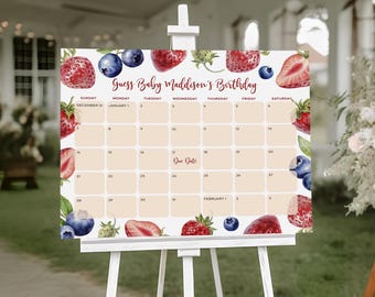 Puede incluir: Un caballete blanco muestra un calendario con el texto "Guess Baby Maddison's Birthday". La cuadrícula del calendario está rodeada de ilustraciones de acuarela de fresas y arándanos. El calendario incluye fechas y días de la semana.