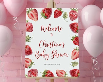 May include: White welcome sign with red strawberries and the text "Welcome to Christina's Baby Shower October 15th, 2026".