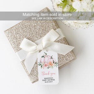 May include: A white gift tag with pink and orange watercolor pumpkins and flowers. The tag says "Thank you Amanda's Baby Shower 06.05.2019".