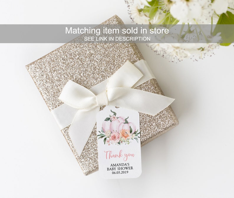 May include: A white gift tag with pink and orange watercolor pumpkins and flowers. The tag says "Thank you Amanda's Baby Shower 06.05.2019".