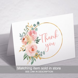 May include: A white thank you card with a gold circle and pink flowers. The text "Thank you" is written in pink inside the circle. The card has the text "Matching item sold in store SEE LINK IN DESCRIPTION" at the bottom.