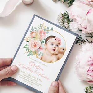 May include: A pink and gold first birthday invitation with a floral design and a photo of a baby girl in a circle. The text on the invitation reads "Please join us to celebrate Christina's 1st Birthday & Dedication. Sunday July 7, 2021 at 2PM. Farmhouse Park Hotel, 1234 Benedum Drive, Key West, FL 10011. RSVP to Christina (000) 000-00-00 by June 1st, 2020."