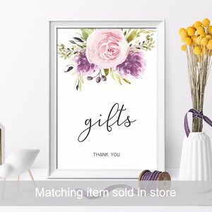 May include: A white frame with a watercolor floral design in shades of pink and purple. The text "gifts" is written in black cursive script with the words "Thank You" below.