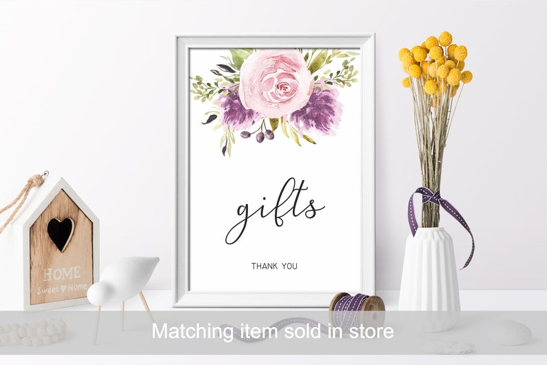 May include: A white frame with a watercolor floral design in shades of pink and purple. The text "gifts" is written in black cursive script with the words "Thank You" below.