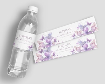 May include: Water bottle labels with a purple and white butterfly design. The labels say "Sophia's Bridal Shower" with a date and location.