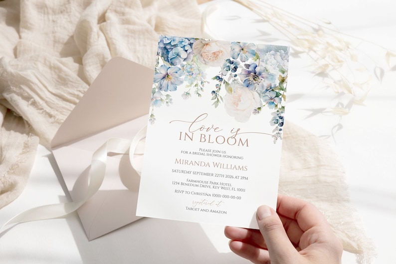 Editable bridal shower invitation featuring blue hydrangeas and greenery. Printable boho dusty blue floral invitation template for bridal brunch or garden-themed events.