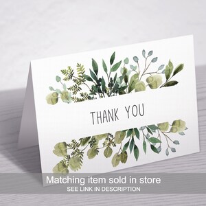 Peut inclure: Une carte blanche avec une bordure florale aquarelle verte et le texte "Merci". La carte a un article assorti vendu en magasin, avec un lien dans la description.
