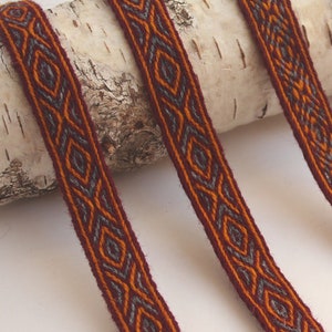 Tablet woven wool trim. Viking reenactment. Red, orange and light gray.