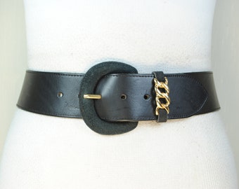 Wide black leather belt with gold buckle