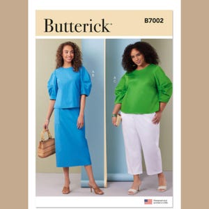 May include: Butterick B7002 sewing pattern featuring two women modeling different outfits. One wears a blue top and skirt, the other a green top and white pants. The pattern is designed and printed in the USA.