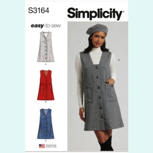 May include: Simplicity sewing pattern S3164 for a button-down dress with a V-neck and pockets. The pattern includes options for a gray, red, and denim dress. The image shows a woman wearing the gray dress with a beret.