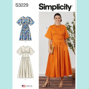 May include: Simplicity sewing pattern S3229 featuring a dress with short sleeves, a wide gathered waistband, and a full skirt. The pattern includes illustrations of a blue floral version and a solid orange version, showing construction details.