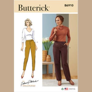 May include: A sewing pattern for pants, featuring two different styles. The pattern is from Butterick and has the number B6910 printed on it. The pattern includes instructions for a pair of brown pants and a pair of mustard yellow pants.