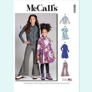 May include: McCall's sewing pattern M8353 featuring girls' clothing designs. The pattern includes a long-sleeved floral top, a short-sleeved dress, a blue dress, and flared pants. The image shows two girls modeling the clothing. The pattern is designed and printed in the USA.