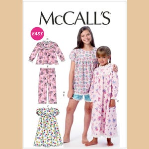 May include: McCall's sewing pattern featuring children's sleepwear designs. The pattern includes options for a long-sleeved top and pants set, a short-sleeved top and shorts set, and a nightgown. The sleepwear designs are shown in pink and white fabrics.