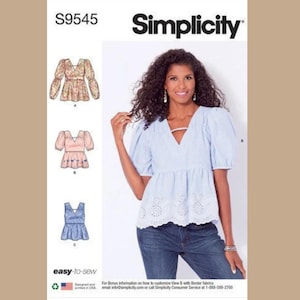 May include: Simplicity sewing pattern S9545. The pattern features three blouse designs with V-necklines and various sleeve styles. The image shows a woman wearing a light blue blouse with eyelet detailing and a keyhole neckline. The pattern is easy-to-sew.