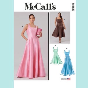 May include: McCall's M8627 sewing pattern featuring a pink square-neckline dress. The image also shows a brown dress and sketches of green and blue dresses. The pattern is designed and printed in the USA.