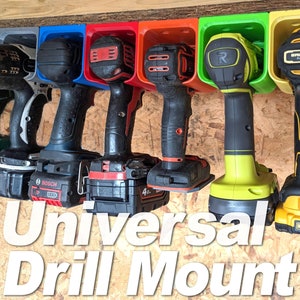 May include: A set of six drill holders, each in a different colour, mounted on a wooden wall. The holders are designed to hold various types of drills, including cordless drills, drill drivers, and impact drivers. The drills are all different brands and colours, including black, blue, green, red, and yellow. The text "Universal Drill Mount" is printed in white on a black background.