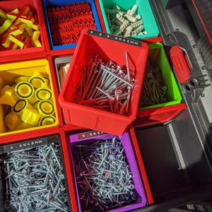 May include: A drawer organiser with multiple compartments filled with various screws, nails, and other hardware. The compartments are labelled with different sizes, such as "3.5 x 55 mm" and "4.0 x 40 mm".