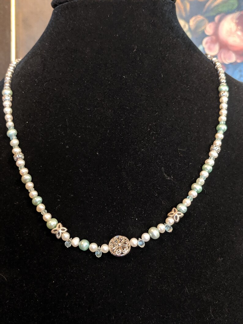 Teardrop-shaped micro faceted aquamarine and Pearl necklace.