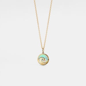 May include: A gold chain necklace with a round pendant featuring a wave design set in opal.